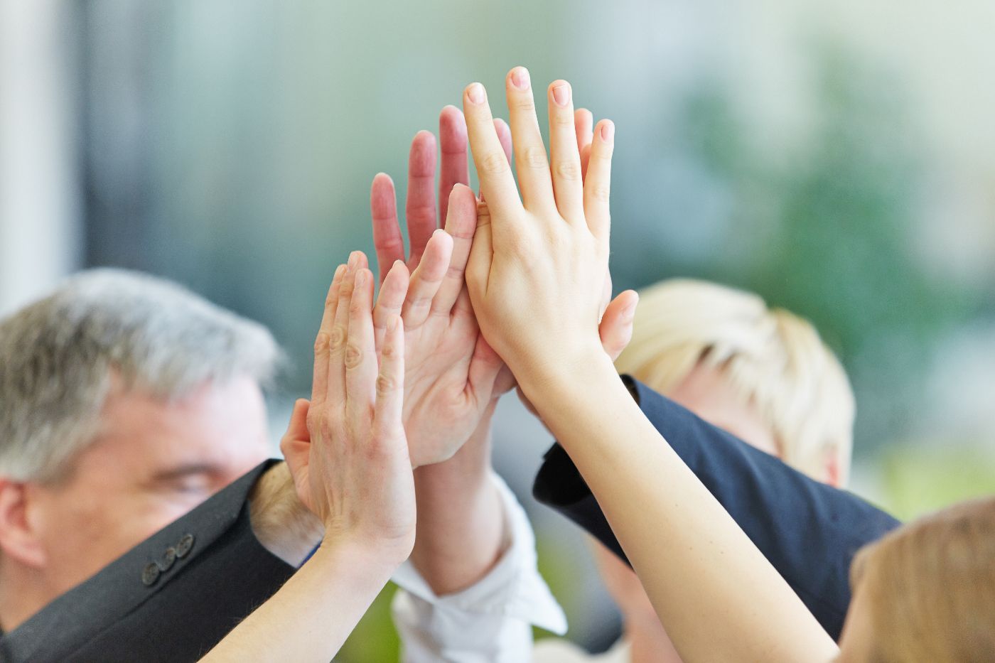 Hände geben sich High Five im Büro